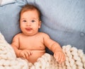 Adorable baby lying down over blanket on the sofa at home Royalty Free Stock Photo