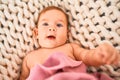 Adorable baby lying down over blanket on the sofa at home Royalty Free Stock Photo