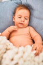 Adorable baby lying down over blanket on the sofa at home Royalty Free Stock Photo