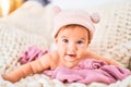 Adorable baby lying down over blanket on the sofa at home