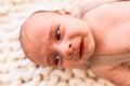 Adorable baby lying down over blanket on the sofa at home Royalty Free Stock Photo