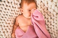 Adorable baby lying down over blanket on the sofa at home Royalty Free Stock Photo