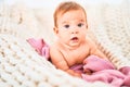 Adorable baby lying down over blanket on the sofa at home Royalty Free Stock Photo