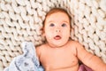 Adorable baby lying down over blanket on the sofa at home Royalty Free Stock Photo