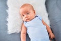 Adorable baby lying down on the sofa at home Royalty Free Stock Photo