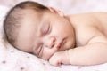 Adorable baby newborn sleeping on stomach on a soft blanket. A newborn baby in a hat sleeps on a soft blanket Royalty Free Stock Photo