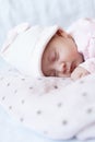 Adorable baby newborn sleeping on stomach on a soft blanket. A newborn baby in a hat sleeps on a soft blanket Royalty Free Stock Photo