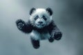 Adorable Baby Panda Mid Jump with a Soft Blue Background, Capturing the Essence of Playful Wildlife and Endangered Species Royalty Free Stock Photo