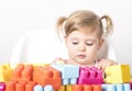 Adorable baby playing with colorful toys on an isolated background Royalty Free Stock Photo