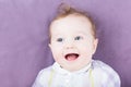 Adorable baby on a purple blanket