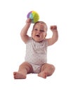 Adorable baby raised the ball above his head. Isolated on white background Royalty Free Stock Photo