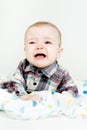 Adorable baby screaming in a plaid shirt