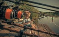 Baby sit on river pier with fishing rod and fishing Royalty Free Stock Photo