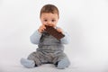 Adorable baby sitting and eating a plate of chocolate Royalty Free Stock Photo