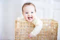 Adorable baby sitting in a laundry basket Royalty Free Stock Photo