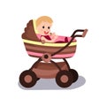 Adorable baby sitting in a modern pram, transporting Royalty Free Stock Photo