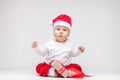 Adorable baby wearing a Santa hat opening Christmas presents Royalty Free Stock Photo