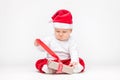 Adorable baby wearing a Santa hat opening Christmas presents Royalty Free Stock Photo