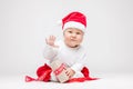 Adorable baby wearing a Santa hat opening Christmas presents Royalty Free Stock Photo