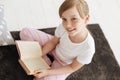 Adorable beautiful girl spending weekend with a nice book