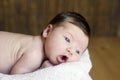 Adorable beautiful newborn baby looking up with a look of wonderment