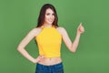 Adorable beautiful young cheerful brunette woman show thumb up on isolated green background. Lifestyle fashion Beauty People