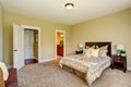 Adorable bedroom interior with beige walls, wooden furniture