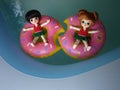Adorable BJD Ball Joint Doll branded LATI in swimming suit. They`re ready to play water with colorful pool floats.