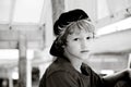 Adorable black and white portrait of cute boy with backwards hat