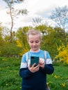 Adorable blogger child girl chatting in social media smartphone learning language listening audio books podcast outdoor Royalty Free Stock Photo