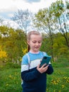 Adorable blogger child girl chatting in social media smartphone learning language listening audio books podcast outdoor Royalty Free Stock Photo