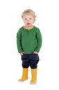 Adorable blond baby with yellow gumboots