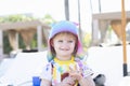 Adorable Blond-Haired Blue-Eyed Toddler Girl Standing on the Beach Wearing Good Sun Protection Clothes and a Colorful Hat in Punta Royalty Free Stock Photo