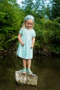 Adorable blond preschool girl playing in river Royalty Free Stock Photo