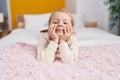 Adorable blonde girl smiling confident lying on bed at bedroom Royalty Free Stock Photo