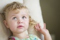 Adorable Blonde Haired and Blue Eyed Little Girl in Chair