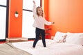 Adorable blonde toddler smiling confident dancing on bed at bedroom Royalty Free Stock Photo
