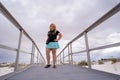 Adorable blonde woman photographer stands on the boardwalks of White Sands NM Royalty Free Stock Photo