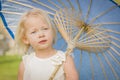 Adorable Blue-Eyed Baby Girl Holding Parasol Outside At Park Royalty Free Stock Photo