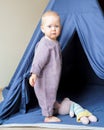 Adorable little child standing in play tent with toys Royalty Free Stock Photo