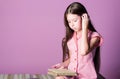 Adorable bookworm. Reading literature as hobby. Fiction and nonfiction. Cute small child reading book on violet Royalty Free Stock Photo