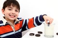 Adorable Boy Dunking Cookies in Milk Royalty Free Stock Photo