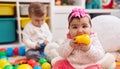 Adorable boy and girl playing with balls sucking duck toy at kindergarten Royalty Free Stock Photo