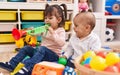 Adorable boy and girl playing trumpet holding balls at kindergarten Royalty Free Stock Photo