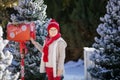 Adorable boy with glasses sending her letter to Santa, Christmas time Royalty Free Stock Photo