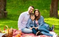 Adorable boy with his parents enjoying sunny summer day on picnic in countryside Royalty Free Stock Photo