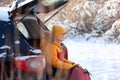 Adorable boy with hot tea or cocoa in his hands sitting in black car at winter day. Travel tourism at winter time