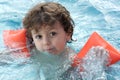 Adorable boy learning to swim Royalty Free Stock Photo