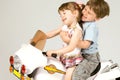 Adorable boy and little girl sitting on toy bike Royalty Free Stock Photo