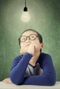 Adorable boy looking at bright light bulb Royalty Free Stock Photo